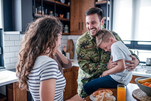 A veteran with his family in their kitchen